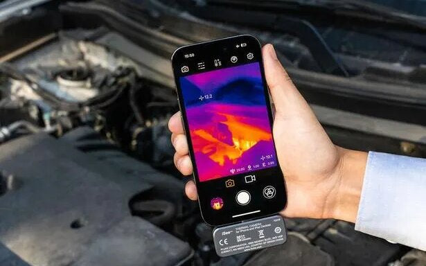 A Fluke iSee TC01 phone thermal camera held over a car's engine bay